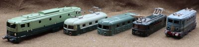 several toy trains are lined up next to each other on the ground