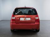 the rear end of a red car parked in a garage