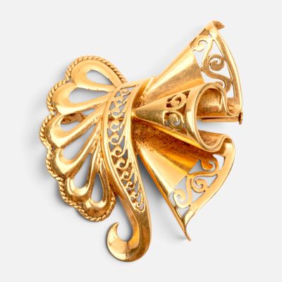 an image of a gold colored brooch with a bow on it