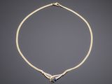 an 18k gold necklace with a blue sapphire and diamonds