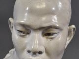 a close up of a statue of a man with a bald head