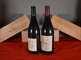two bottles of wine sitting next to each other on a table