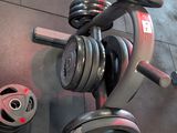 a gym room with dumbs and weights on the floor