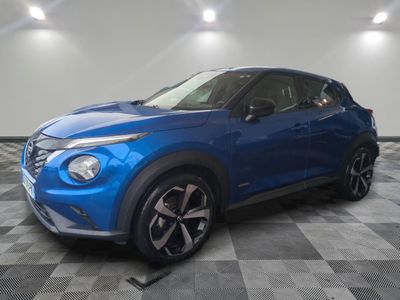 a blue nissan c - hr suv parked on a checkered floor