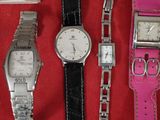five different types of watches on a red cloth