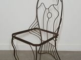 a metal chair with a fish design on the back