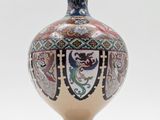 a vase with a design on it sitting on a table