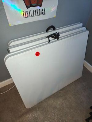 a white refrigerator with a red button on it