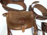 a brown purse and belt on a white surface