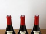 three bottles of wine sitting on a table next to each other