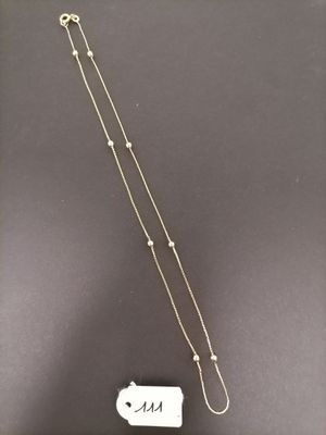 a silver necklace with a chain and a tag on it