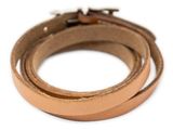 a close up of a pair of leather bracelets on a white background