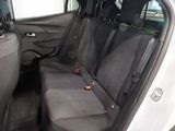 the back seats of a white car with a black seat belt