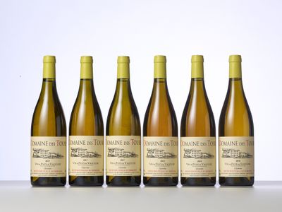 six bottles of wine are lined up in a row on a table