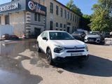 a white suv parked in front of a building
