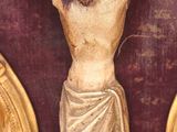 a statue of jesus on the cross on the wall