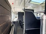 a view of the inside of a bus with black seats