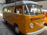 a yellow vw bus parked in a garage