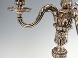 a silver candelier with two candles on it
