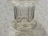 un vase en verre posé sur un socle transparent