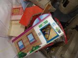 a box with a doll house inside of it on a bed