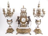 four different types of clocks on display on a table