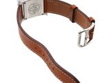 a close up of a watch on a white background with a brown strap