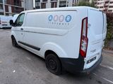 a white van parked in a parking lot next to a building