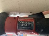 a close up of a red and black drill on a table