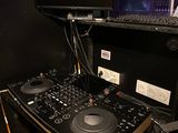 a computer and a dj controller on a desk