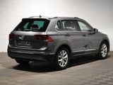 the rear end of a gray volkswagen suv parked in a garage