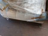 a pile of boxes wrapped in plastic sitting on the floor