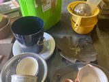 a table that has a lot of dishes and cups on it