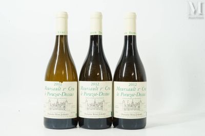 three bottles of wine sitting on top of a white table