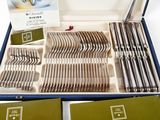 many forks and spoons in a box on the table