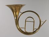 a brass instrument hanging from the ceiling in a room