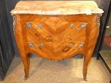 une petite commode en bois avec un plateau en marbre