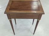 a small wooden table with a drawer on top of it