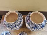 two blue and white vases sitting on a wooden table