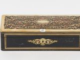 an image of a black and gold box on a white surface