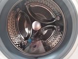 a close up of a washing machine with a pair of scissors in it