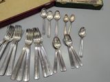 a lot of spoons and forks on the table