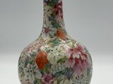 a vase with a floral design on it sitting on a table