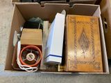 a box with various items in it on the floor
