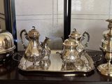 a silver tray with silver items on it on a table