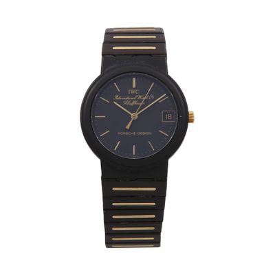 a close up of a black and gold watch on a white background