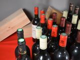 many bottles of wine sitting on a red table