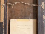 an old picture frame with a piece of paper hanging from it