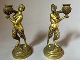 pair of antique brass figurines of a man and a woman holding pots