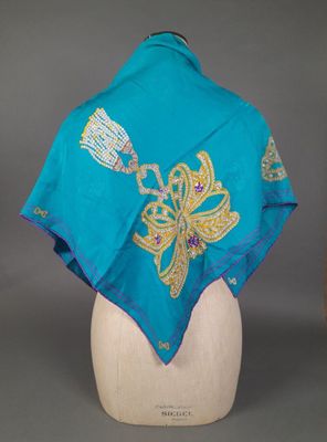 a close up of a blue shawl on a mannequin head